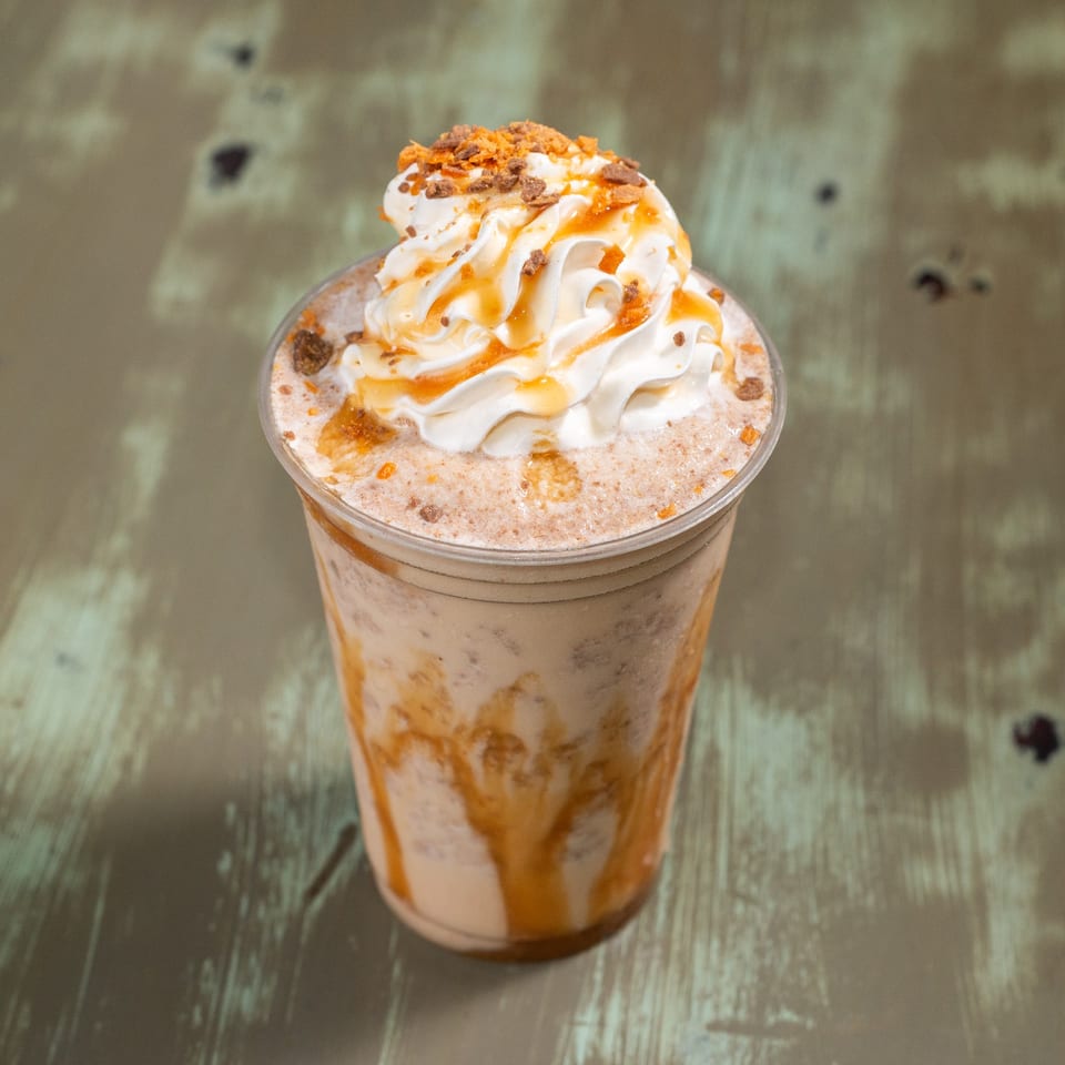 Common Ground Coffee & Eatery's blended coffee drink with whipped cream, caramel drizzle, and cookie crumbles.