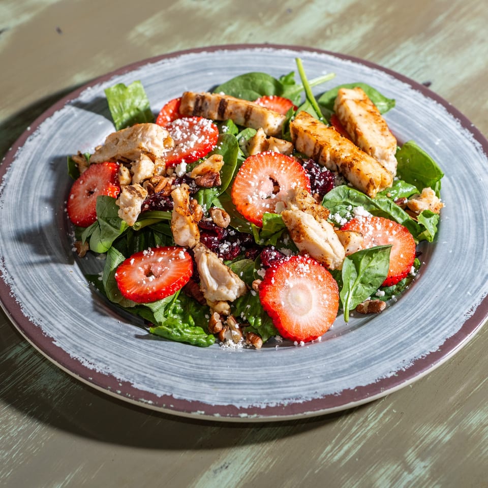 Common Ground Coffee & Eatery's grilled chicken and strawberry salad with spinach, nuts, and cheese.